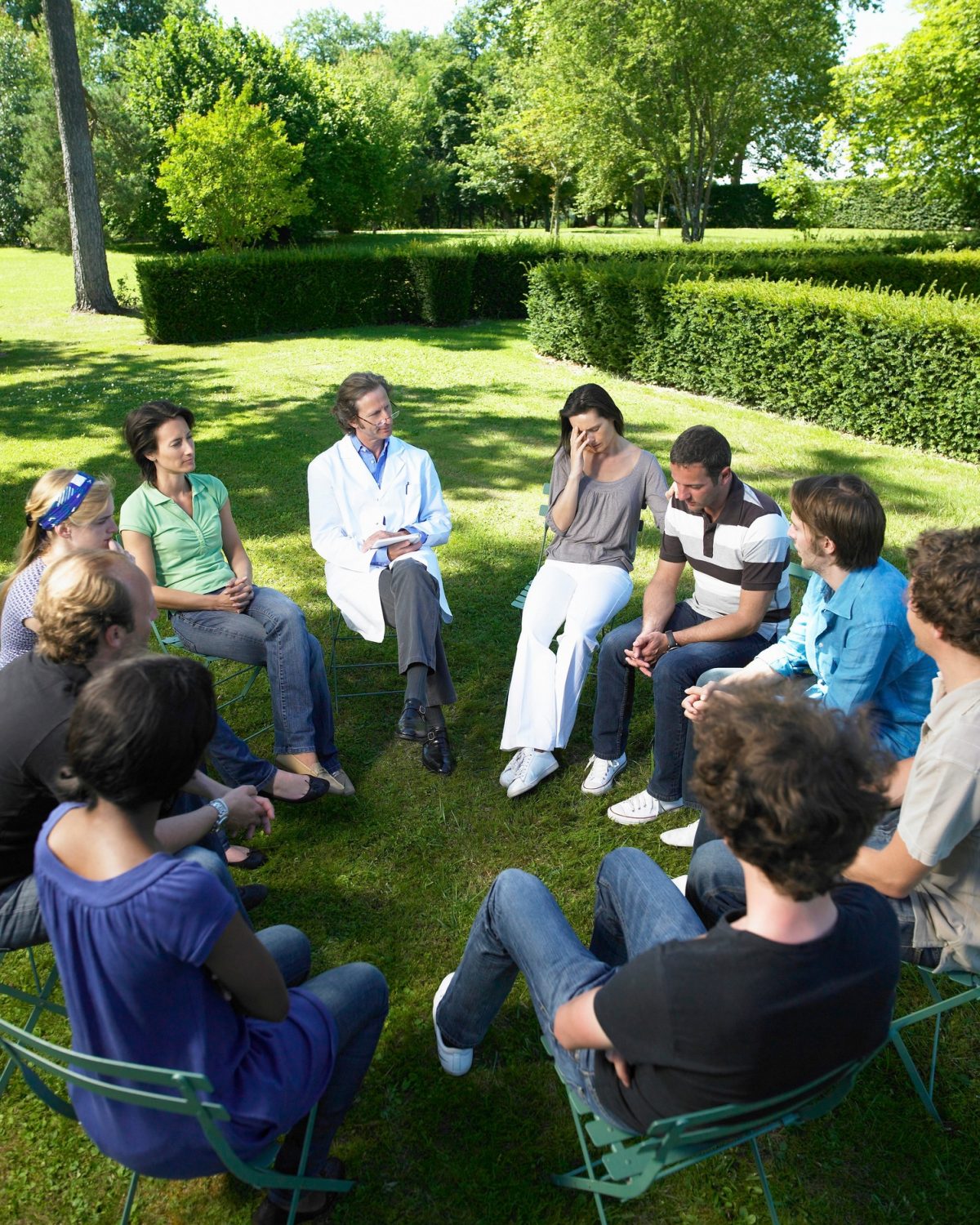 Circle of people in rehab, outdoors